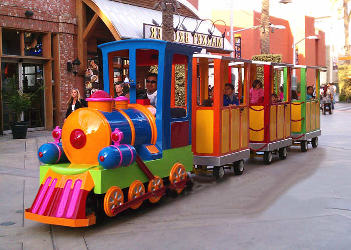 kids ride on tourist trains at amusement park